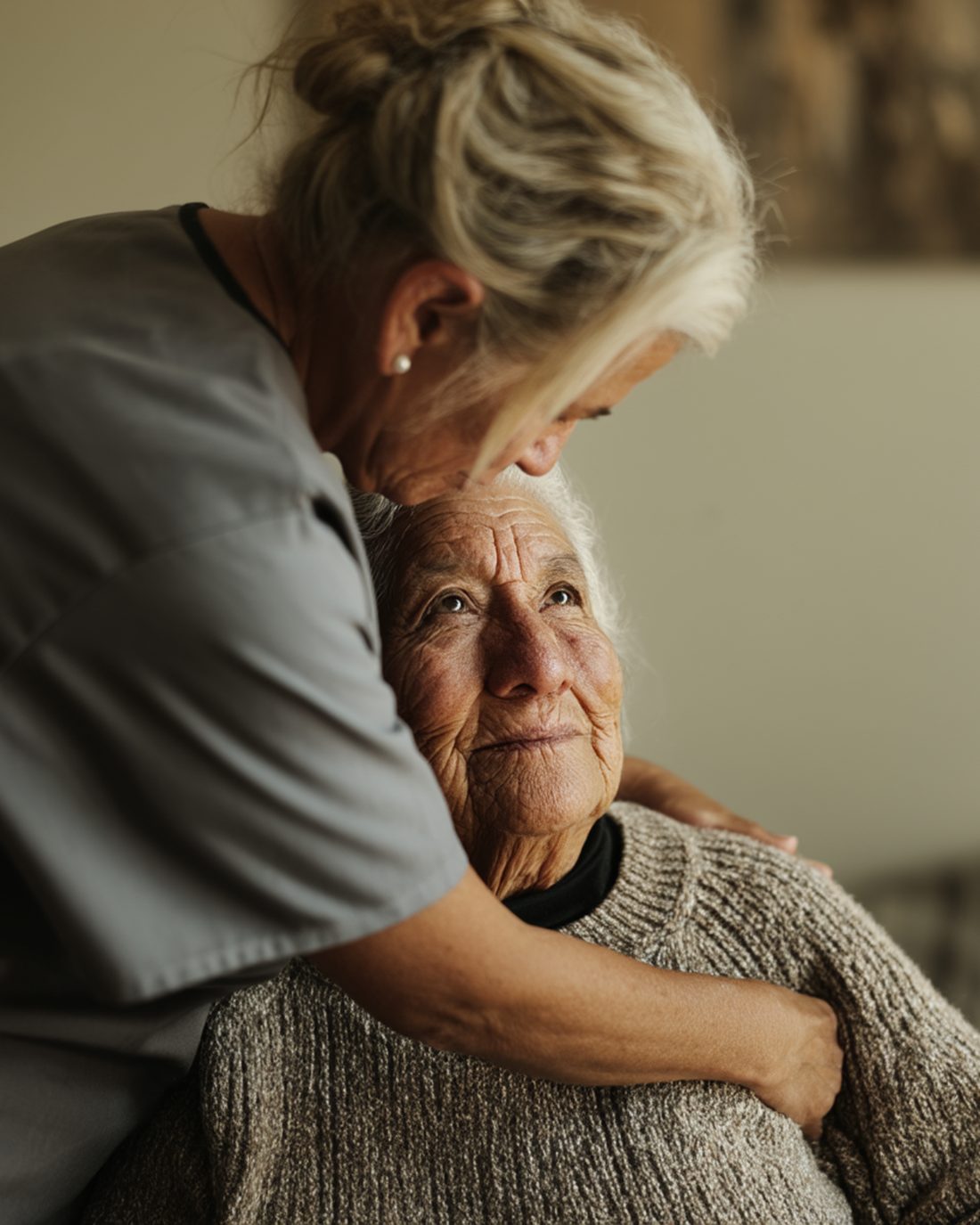 Kassy Health nurse hugging her elderly patient — quiet, intimate moment at home
